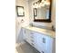 Bathroom featuring double sinks, framed mirror, and marble countertop at 495 Schooner St, North Port, FL 34287