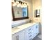Modern bathroom vanity featuring double sinks, wood trim mirror, and brushed nickel fixtures at 495 Schooner St, North Port, FL 34287