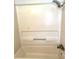 Clean bathtub with shower head, shelving and grab bar at 495 Schooner St, North Port, FL 34287