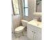 This well-lit bathroom features a toilet, vanity and decorative artwork at 495 Schooner St, North Port, FL 34287