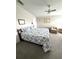 Serene bedroom with ceiling fan, seashell bedding, and comfortable seating area at 495 Schooner St, North Port, FL 34287