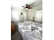 Well lit bedroom with ceiling fan, three closets and comfortable bed at 495 Schooner St, North Port, FL 34287