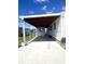 Spacious carport offers covered parking and convenient access to home's entrance with verdant lawn at 495 Schooner St, North Port, FL 34287
