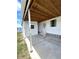 Spacious carport offers covered parking and convenient access to home's entrance with green lawn and lake at 495 Schooner St, North Port, FL 34287