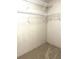 Walk-in closet with installed shelves, and neutral colored carpet at 495 Schooner St, North Port, FL 34287