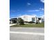Charming single-story home with vinyl siding, carport, landscaped yard, and meticulous, low maintenance curb appeal at 495 Schooner St, North Port, FL 34287