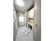 Hallway with marble look floors, built-in desk, cabinets and door to outside at 495 Schooner St, North Port, FL 34287