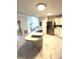 Kitchen with a center island that has a cooktop, tile backsplash and stainless steel refrigerator at 495 Schooner St, North Port, FL 34287