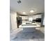 Kitchen with a center island that has a cooktop, tile backsplash and stainless steel refrigerator at 495 Schooner St, North Port, FL 34287