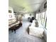 Large living room with multiple windows, ceiling fan and multiple couches at 495 Schooner St, North Port, FL 34287