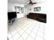 Relaxing living room with tile flooring, a ceiling fan, and comfortable brown leather reclining sofa at 495 Schooner St, North Port, FL 34287