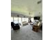 Large living room with multiple windows, ceiling fan and multiple couches at 495 Schooner St, North Port, FL 34287