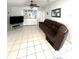 View of living room with dark brown couch, entertainment center, ceiling fan and built in wet bar area at 495 Schooner St, North Port, FL 34287
