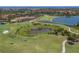 An aerial view of a Primary-planned community showcasing a golf course, lakes, and lush landscaping at 500 Padova Way, North Venice, FL 34275