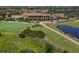 Aerial view of a beautifully landscaped community showcasing the clubhouse, golf course, and surrounding nature at 500 Padova Way, North Venice, FL 34275