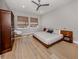 Modern bedroom with wood flooring, platform bed, and neutral walls, enhanced by natural light at 500 Padova Way, North Venice, FL 34275