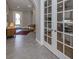 Inviting entryway features gray tile floors, neutral walls, an arched doorway and an adjacent study with French doors at 500 Padova Way, North Venice, FL 34275