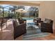 Comfortable screened patio with cushioned seating around glass table, all overlooking pool area at 500 Padova Way, North Venice, FL 34275