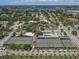 Aerial view showcasing tennis courts, playground, and lush landscaping in a desirable neighborhood at 501 Dona Dr, Nokomis, FL 34275