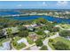 Overhead view showcasing canal-front homes nestled within a vibrant, green landscape and serene coastal backdrop at 501 Dona Dr, Nokomis, FL 34275