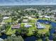 Vast aerial view of the homes, waterways, and dense greenery, capturing the essence of waterfront community living at 501 Dona Dr, Nokomis, FL 34275