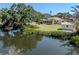 A tranquil view of the backyard, dock, and waterfront, offering a serene escape at 501 Dona Dr, Nokomis, FL 34275