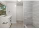 Modern bathroom featuring a stylish vanity, sleek fixtures, and a beautifully tiled shower at 501 Dona Dr, Nokomis, FL 34275