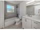 Modern bathroom with stylish tile, updated fixtures, and vanity with storage at 501 Dona Dr, Nokomis, FL 34275