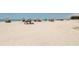Scenic beach view with colorful umbrellas and open sand at 501 Dona Dr, Nokomis, FL 34275