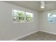 A bright bedroom with large windows, ceiling fan, and tile flooring at 501 Dona Dr, Nokomis, FL 34275