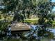 This image shows a private dock with a relaxing bench, perfect for enjoying the water at 501 Dona Dr, Nokomis, FL 34275
