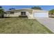 Inviting single-story home with a manicured lawn, clean lines, and a two-car attached garage at 501 Dona Dr, Nokomis, FL 34275