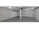 Spacious garage interior with gray floors, white walls, high ceiling and two doors at 501 Dona Dr, Nokomis, FL 34275