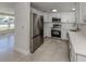 Bright kitchen with stainless steel appliances, quartz countertops and white cabinetry at 501 Dona Dr, Nokomis, FL 34275