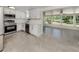 Bright kitchen features stainless steel appliances and open layout to the sun room at 501 Dona Dr, Nokomis, FL 34275