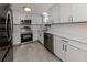 Updated kitchen featuring stainless steel appliances, quartz countertops and white cabinetry at 501 Dona Dr, Nokomis, FL 34275