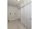 Bright laundry area with white cabinets, beige tile flooring, and a utility closet at 501 Dona Dr, Nokomis, FL 34275