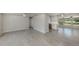 Open-concept living area with tile flooring, multiple windows, and ceiling fan at 501 Dona Dr, Nokomis, FL 34275