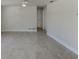 Neutral open living space with tile flooring, base molding, and bright lighting at 501 Dona Dr, Nokomis, FL 34275