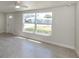 Bright living area with large window, tile flooring, and neutral paint at 501 Dona Dr, Nokomis, FL 34275