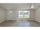 Bright living area with large window, ceiling fan, and tile flooring at 501 Dona Dr, Nokomis, FL 34275