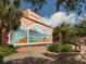 Exterior detail of the Venice Theater with a mural, fountain and palm trees enhancing the artistic facade at 501 Dona Dr, Nokomis, FL 34275