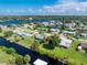 Aerial shot of a waterfront property, surrounded by canals, lush greenery, with easy water access at 506 Buena Vista Dr, Nokomis, FL 34275