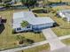 Aerial view of a well-maintained home with a spacious driveway and lush green lawn in a neighborhood at 506 Buena Vista Dr, Nokomis, FL 34275