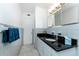 Bright bathroom with granite vanity, and decorative mirror at 506 Buena Vista Dr, Nokomis, FL 34275