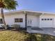 Clean exterior with a well manicured yard, fresh landscaping, and a three-car garage at 506 Buena Vista Dr, Nokomis, FL 34275