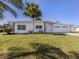 Beautifully landscaped single-story home with a three-car garage and a well manicured front yard at 506 Buena Vista Dr, Nokomis, FL 34275