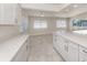 Bright kitchen featuring white cabinets, quartz countertops, and a spacious layout, perfect for modern living at 506 Buena Vista Dr, Nokomis, FL 34275
