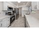 Modern kitchen features new stainless steel appliances and white countertops at 506 Buena Vista Dr, Nokomis, FL 34275
