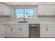 Bright and modern kitchen featuring quartz countertops, stainless steel appliances, and white shaker cabinets at 506 Buena Vista Dr, Nokomis, FL 34275